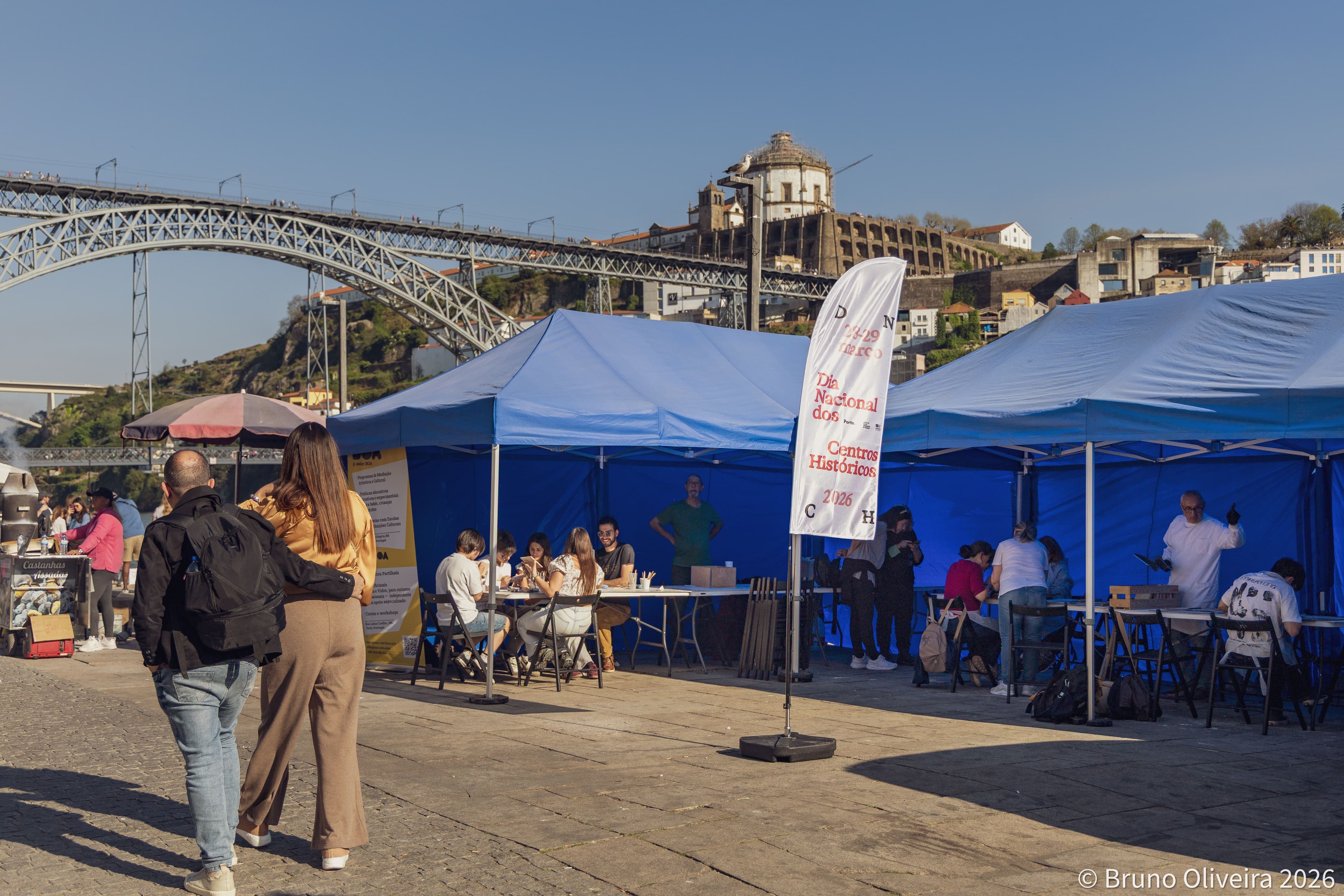 Participants focus on tile restoration techniques in Cais da Ribeira.