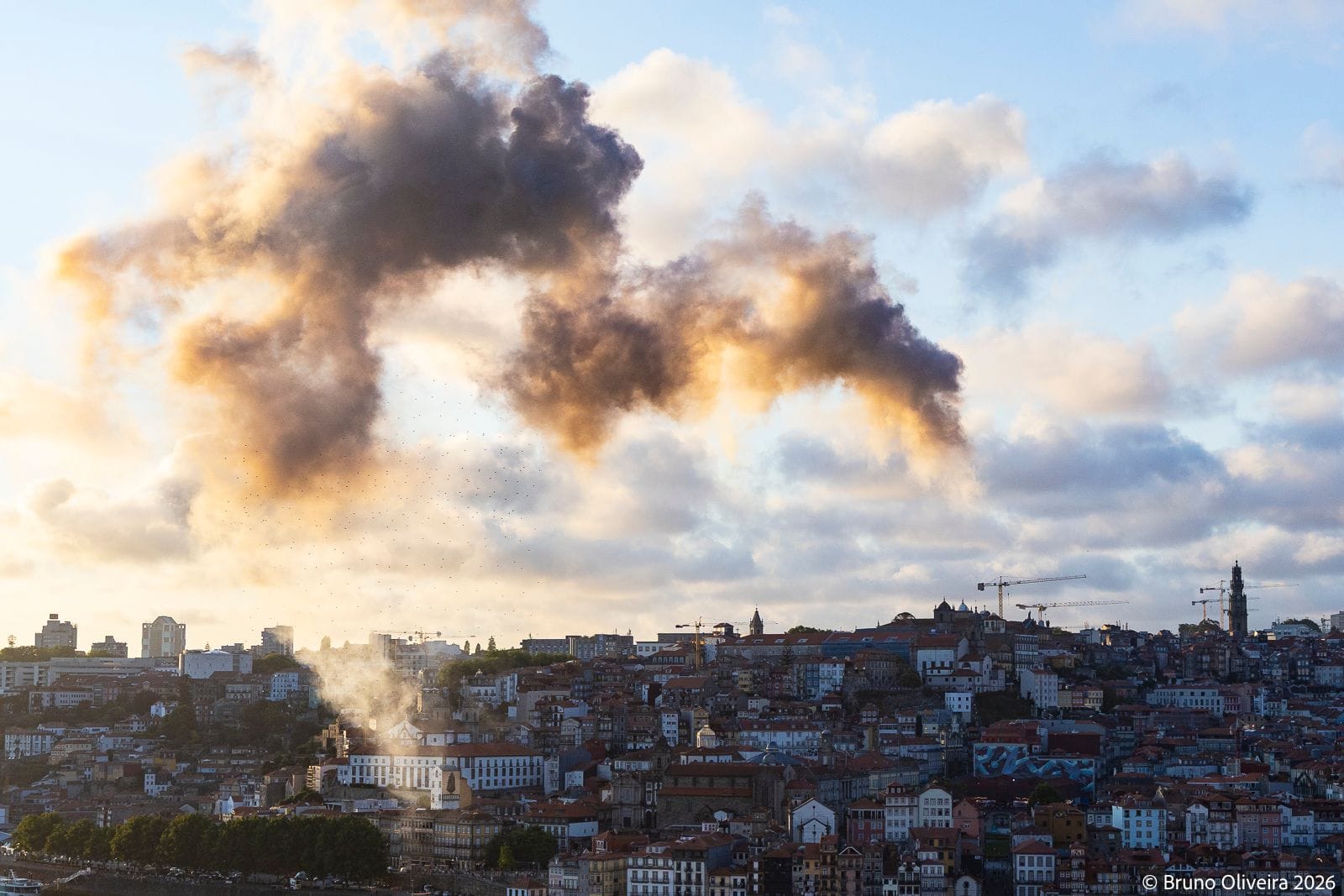 Smoke formations above Porto appear to take the shape of a dragon.